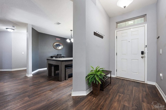 entryway featuring dark hardwood / wood-style floors and a textured ceiling