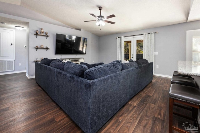 living room with french doors, dark hardwood / wood-style flooring, a textured ceiling, ceiling fan, and lofted ceiling