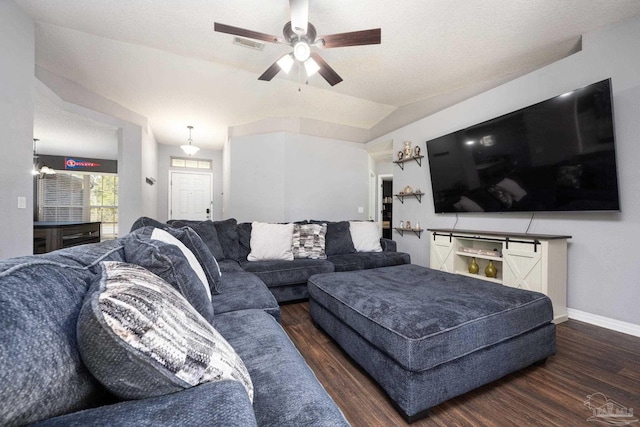 living room with a textured ceiling, dark hardwood / wood-style flooring, ceiling fan, and lofted ceiling