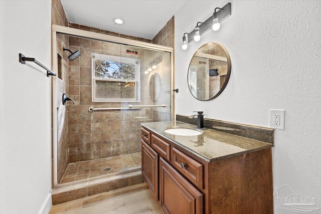 bathroom with vanity and a shower with shower door