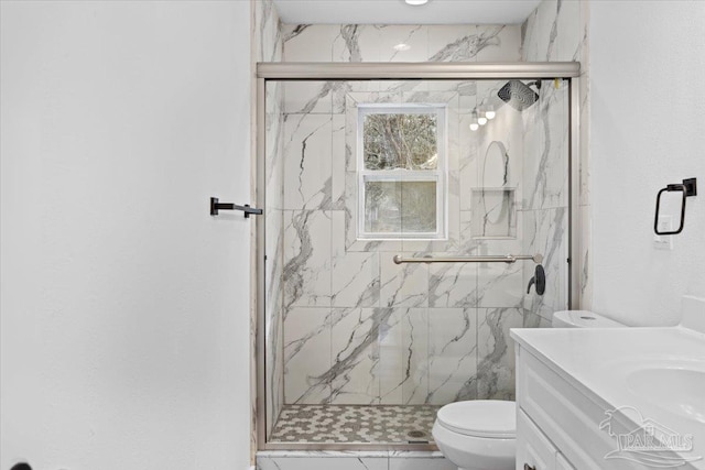 bathroom featuring walk in shower, vanity, and toilet