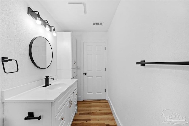 bathroom with vanity and hardwood / wood-style floors