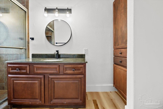 bathroom featuring vanity, hardwood / wood-style flooring, and walk in shower