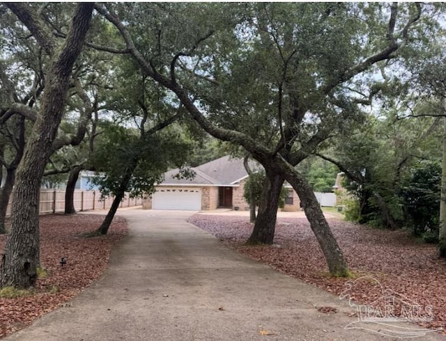 4713 Hickory Shores Blvd, Gulf Breeze, FL 32563 - view of property hidden behind natural elements with driveway and an attached garage