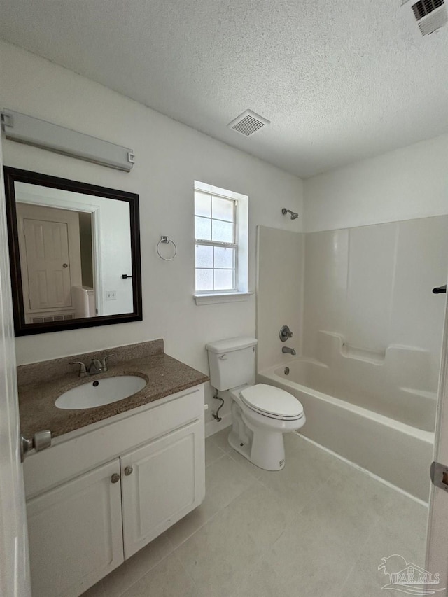 full bathroom with a textured ceiling, vanity, toilet,  shower combination, and tile patterned floors