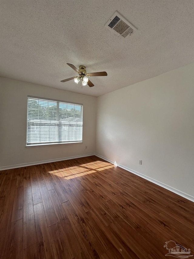 spare room featuring a textured ceiling, hardwood / wood-style floors, and ceiling fan