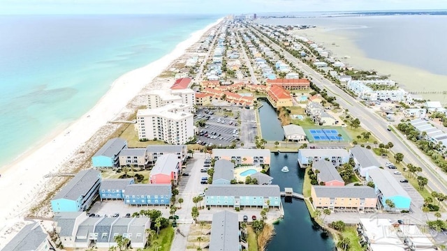 birds eye view of property with a water view and a view of the beach