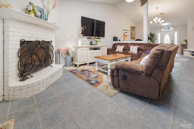 tiled living room featuring lofted ceiling, a chandelier, and a brick fireplace