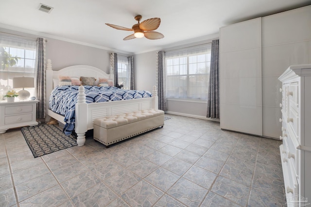 bedroom featuring ceiling fan, crown molding, and multiple windows