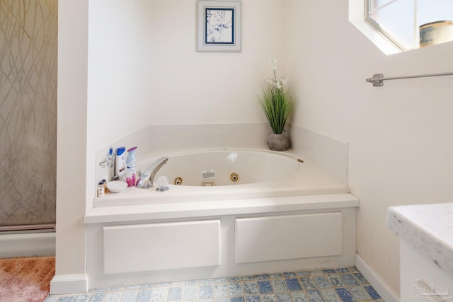 bathroom featuring a skylight and a bathing tub