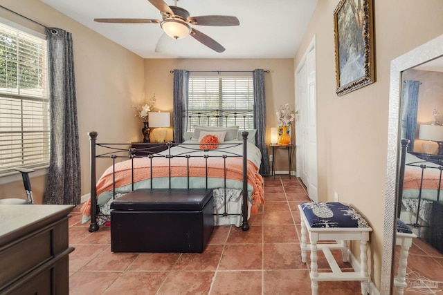 bedroom with tile patterned flooring and ceiling fan