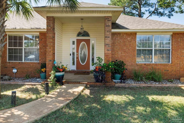 entrance to property featuring a lawn