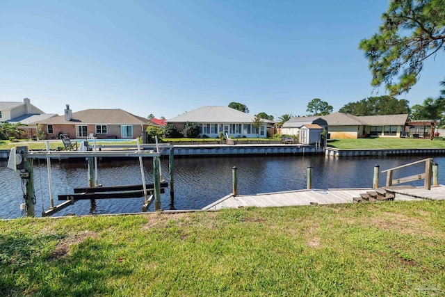 view of dock featuring a water view and a yard