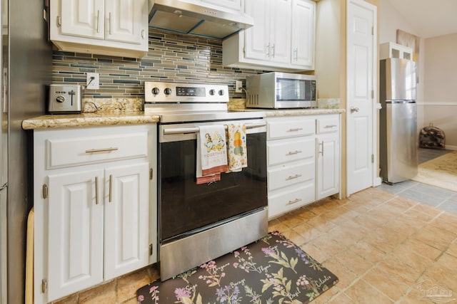 kitchen with tasteful backsplash, light stone counters, extractor fan, white cabinetry, and stainless steel appliances