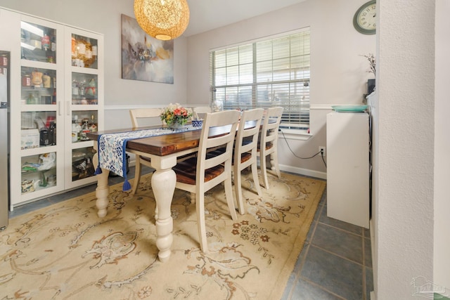 tiled dining space with a notable chandelier