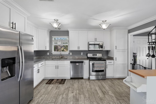 kitchen with white cabinetry, sink, and appliances with stainless steel finishes