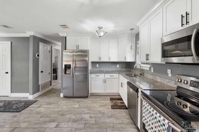 kitchen with hanging light fixtures, white cabinetry, sink, and stainless steel appliances