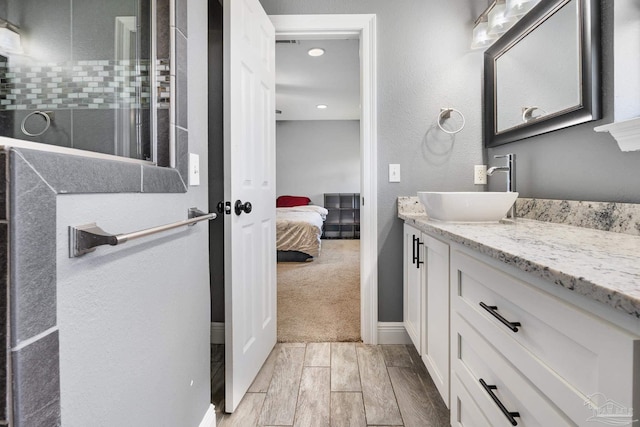 bathroom featuring vanity and a shower