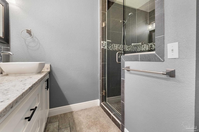 bathroom featuring vanity and a shower with shower door