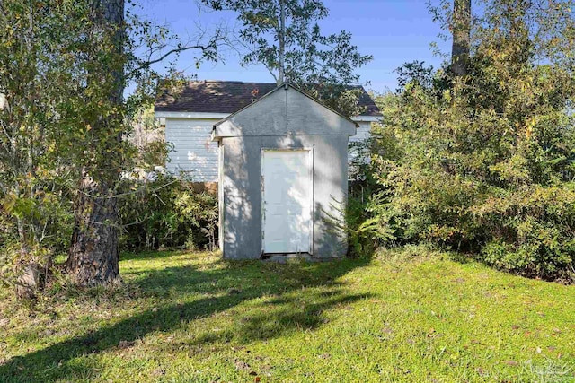 view of outdoor structure featuring a lawn