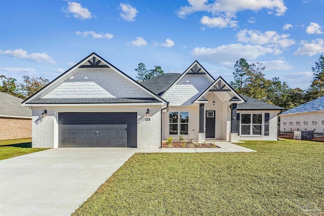 6563 Gentle Rain Dr, Milton, FL 32570 - view of front facade with an attached garage, concrete driveway, a front lawn, brick siding, and roof with shingles