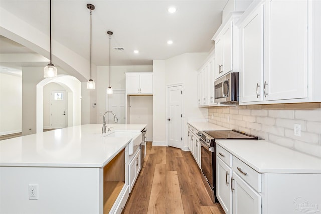 6563 Gentle Rain Dr, Milton, FL 32570 - kitchen featuring appliances with stainless steel finishes, a sink, recessed lighting, white cabinets, and decorative backsplash