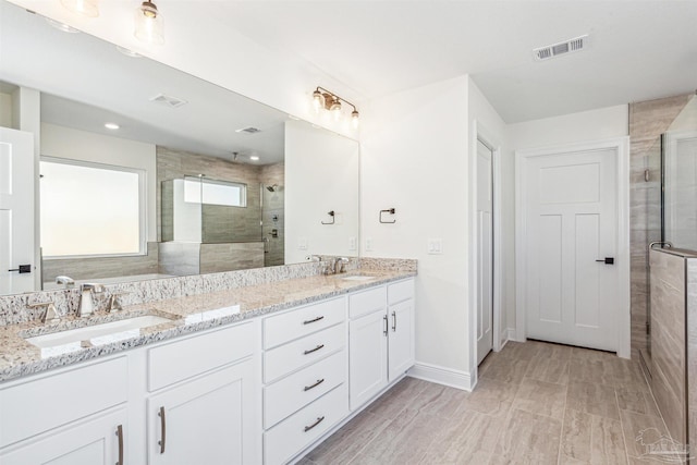 6563 Gentle Rain Dr, Milton, FL 32570 - full bathroom with tiled shower, double vanity, and baseboards