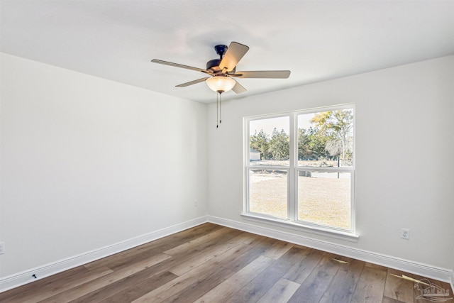 6563 Gentle Rain Dr, Milton, FL 32570 - spare room with baseboards, dark wood-style floors, and a ceiling fan