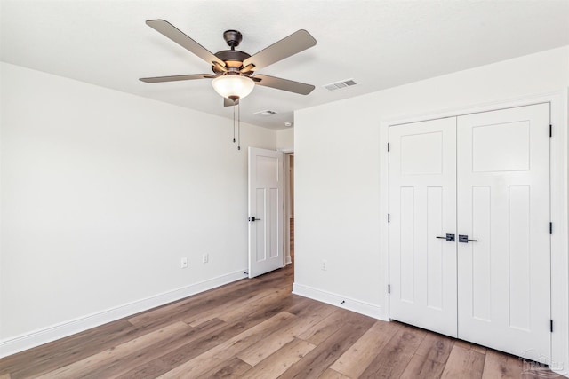 6563 Gentle Rain Dr, Milton, FL 32570 - unfurnished bedroom featuring light wood-style flooring, baseboards, a closet, and ceiling fan