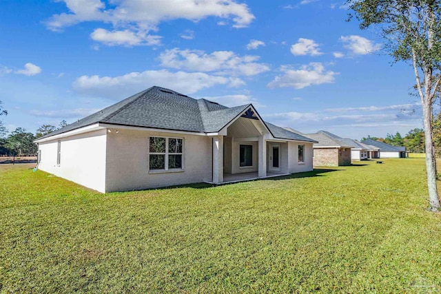 6563 Gentle Rain Dr, Milton, FL 32570 - back of property with roof with shingles and a yard