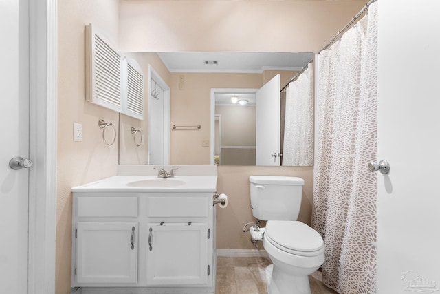 bathroom with vanity, tile patterned flooring, crown molding, and toilet