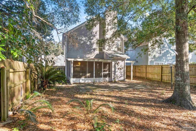 rear view of property with a sunroom