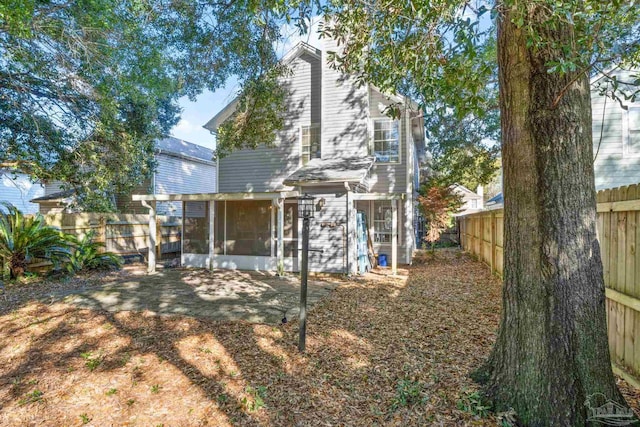 rear view of property with a sunroom and a patio