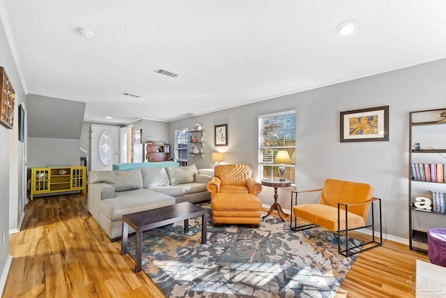 living room with hardwood / wood-style floors and a textured ceiling