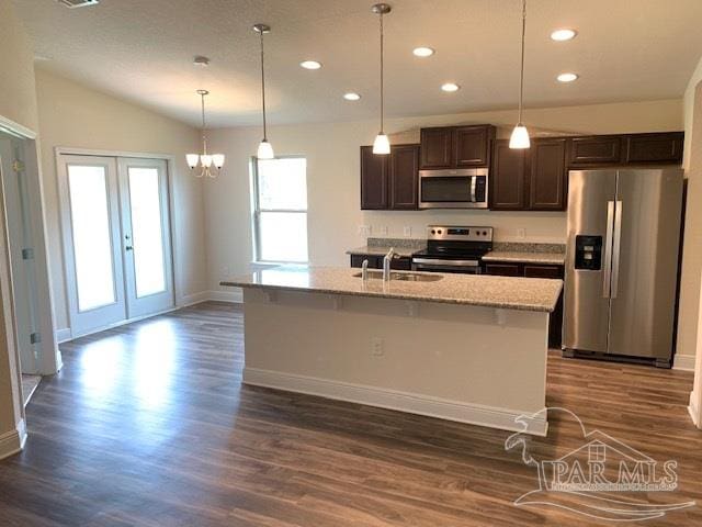 kitchen with dark brown cabinetry, sink, an island with sink, and appliances with stainless steel finishes