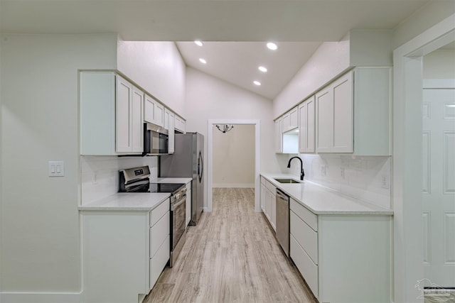 kitchen featuring sink, white cabinets, stainless steel appliances, and light hardwood / wood-style floors