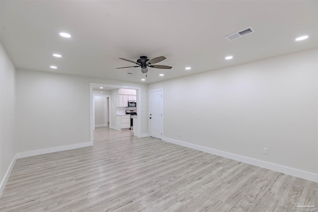 spare room featuring ceiling fan and light wood-type flooring