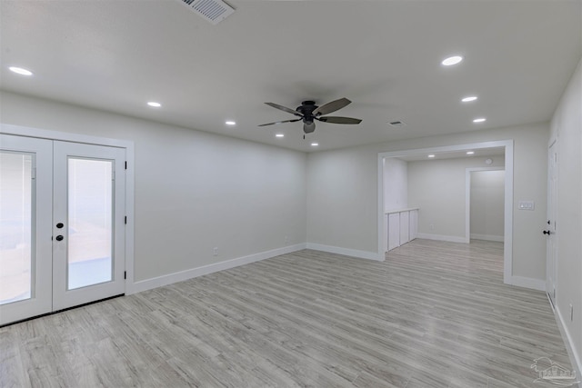 spare room with ceiling fan, french doors, and light wood-type flooring