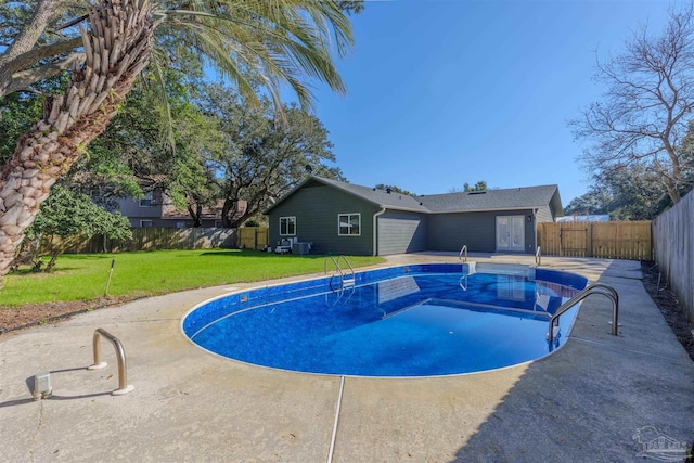 view of swimming pool featuring a lawn and a patio