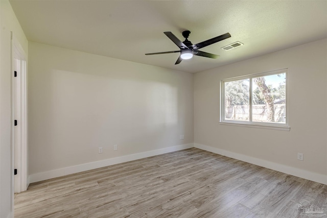 unfurnished room with ceiling fan and light wood-type flooring