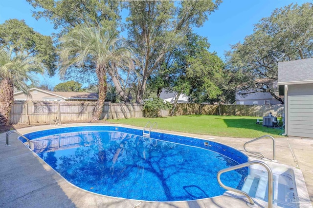 view of pool with central AC and a yard