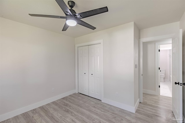 unfurnished bedroom with ceiling fan, light hardwood / wood-style flooring, and a closet