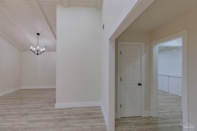 interior space with a chandelier, wooden ceiling, light hardwood / wood-style flooring, and beamed ceiling