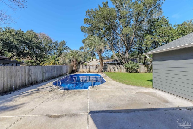 view of pool with a yard and a patio