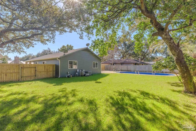 view of yard with a fenced in pool