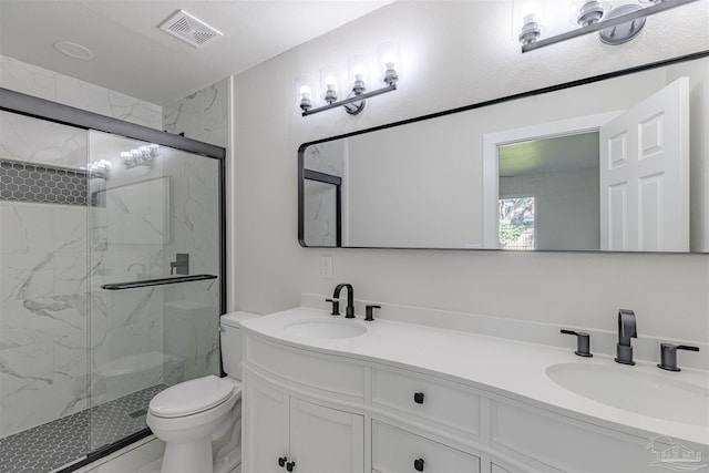 bathroom with vanity, toilet, and a shower with shower door