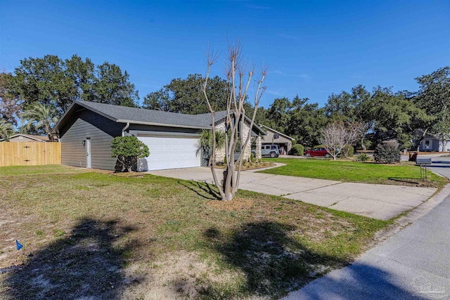 view of front of property featuring a garage and a front lawn