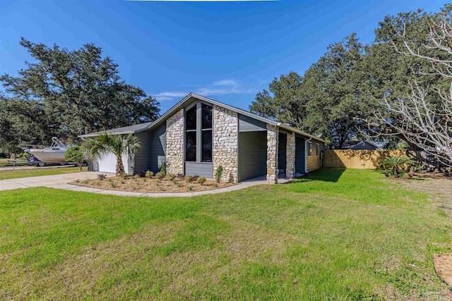 view of side of property with a garage and a lawn