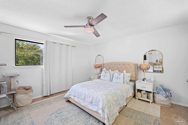 tiled bedroom featuring ceiling fan and a textured ceiling