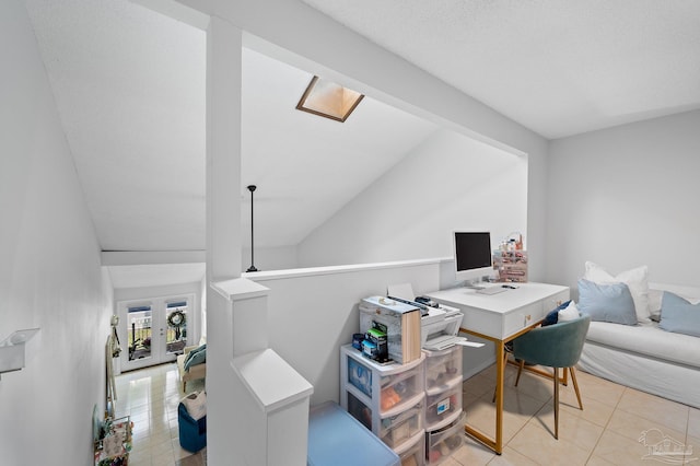 tiled office space featuring lofted ceiling and a textured ceiling